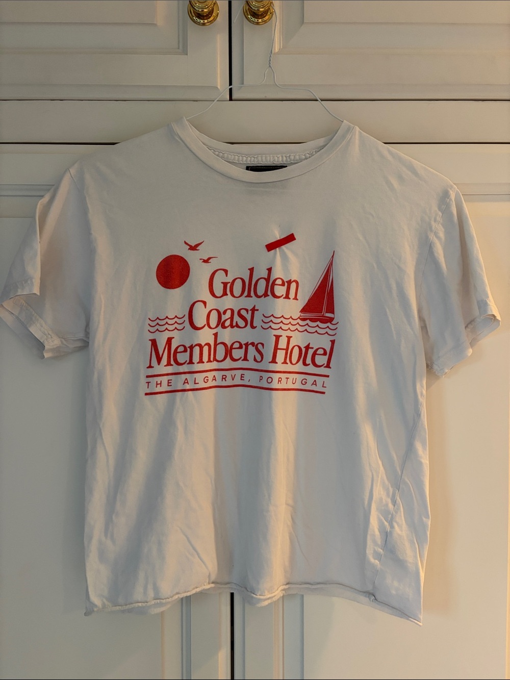 Retrograde- ‘Golden Coast Members Hotel’ -White Tee with Red Graphic